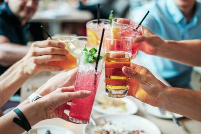 Group of people holds glasses of various alcoholic beverages