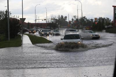 Photo of cars driving through flood water.