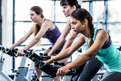 A group of people riding stationary bikes.